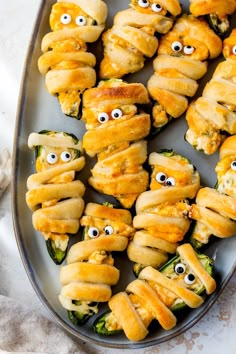 a plate filled with stuffed peppers covered in googly eyes