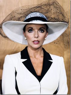 a woman wearing a white hat with black trim on it's brimming