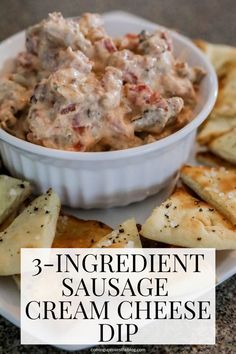 three ingredient sausage cream cheese dip in a white bowl with crackers on the side