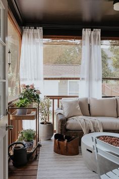 a living room filled with lots of furniture and plants on top of it's windowsill