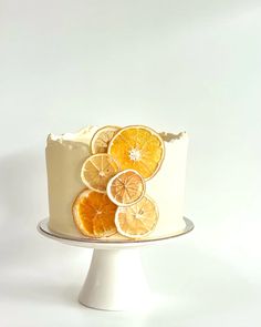 a white cake with orange slices on top