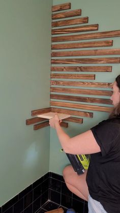 a woman is working on some wood planks in a bathroom wall decorating the walls