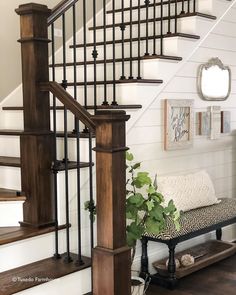 a living room filled with furniture and a stair case