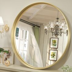 a large round mirror sitting on top of a mantle