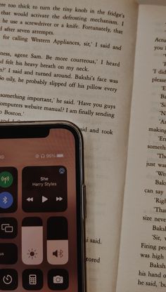 an iphone sitting on top of an open book