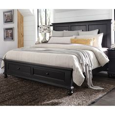 a black bed with two drawers underneath it