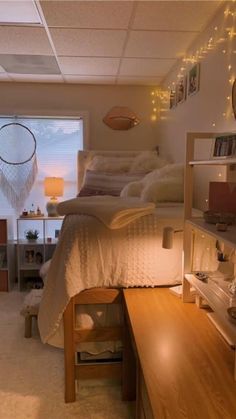 a bedroom with a bed, desk and shelves on the wall in front of it