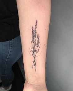 a woman's arm with a flower tattoo on the left side of her wrist