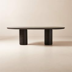 an oval table with two wavy black legs