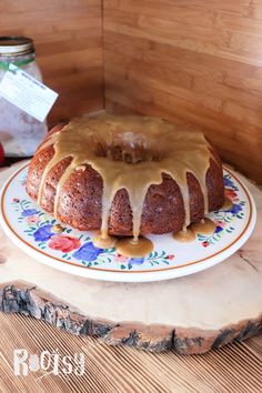 a bundt cake sitting on top of a plate covered in icing and drizzle