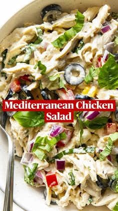 a white plate topped with pasta salad next to a fork