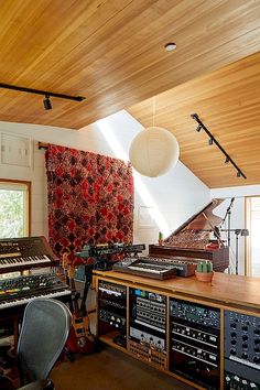 an old recording studio with lots of sound equipment and lights hanging from the rafters