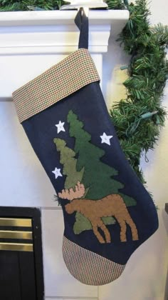 a christmas stocking hanging from a fireplace mantel with moose and stars on it