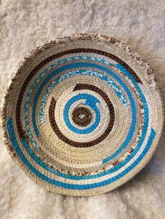 a blue and white basket sitting on top of a rug