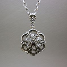 A gorgeous vintage silver necklace pendant with a small rose cut genuine garnet stone. The pendant is stylized as a flower. A great quality collectible Biedermeier style Dutch heritage jewelry item. You may choose to buy this pendant on its own, or with a matching 28 inches (72 cm) handcrafted antique sterling silver chatelaine chain, shown on the photos. The item will be shipped in a gift box. An excellent gift idea! Garnet is the birthstone of January. It is also traditionally known as the gem Antique Silver Jewelry Vintage, Vintage Silver Jewelry Antiques, Vintage Silver Necklace, Dutch Heritage, Vintage Jewelry Antique, Ring Inspo, Antique Silver Jewelry, Silver Necklace Pendant, Heritage Jewellery