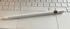 a pen sitting on top of a laptop keyboard