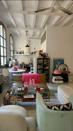 a living room filled with furniture and lots of windows