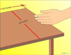 a hand is pointing at the top of a table that has 40 inches on it