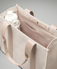 Two-Tone Canvas Tote Bag 10L | Women's Bags,Purses,Wallets | lululemon Beige Bags With Functional Pockets For Everyday Use, Versatile Lululemon Bag With Functional Pockets, Lululemon Rectangular On-the-go Bag, Functional Beige Bags With Pockets, Practical Bags With Water Bottle Pocket For Daily Use, Lululemon Bags With Pockets For Everyday Use, Lululemon Bag With Removable Pouch For Everyday Use, Functional Lululemon Bags For On-the-go, Versatile Lululemon Bags For Everyday