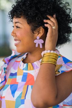 Our Berkeley Bow Earring is an adorable, lightweight beaded statement that adds joy to any outfit! This style is exclusive to The Tiny Tassel and are designed by Mimi's sister, Aiko! All of our earrings are lightweight & hypoallergenic. Earring measures 2 in. L x 1.5 in. W. Spring Party Beaded Drop Earrings, Spring Party Beaded Earrings, Spring Party Beaded Earrings With Dangling Beads, Spring Party Beaded Dangling Earrings, Playful Beaded Summer Earrings, Handmade Playful Earrings For Spring, Spring Jewelry With Dangling Beads, Chic Summer Beaded Earrings, Trendy Pink Beaded Earrings With Ear Wire