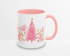 a pink and white coffee mug with a christmas tree on it