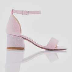 The Bubblegum Glitter Pink Heels designed by Perla for kid girls are the perfect choice for special occasions and dressing up. These stylish heels feature a block heel, providing both stability and a touch of elegance. The sandal buckle strap ensures a snug fit, while the matching strap across the front of the foot adds extra security and style. The sparkly finish gives these heels a dazzling look, making any outfit stand out. Additionally, the pink logo print on the sole adds a unique and playful touch. Ideal for parties, events, or simply feeling glamorous, these heels combine comfort and fashion seamlessly. The Bubblegum Glitter Pink Heels designed by Perla for kid girls are a must-have for any young fashionista's wardrobe. Block heel Sandal buckle strap Matching strap across the front Pink Glitter Heels, Heels Pink, Stylish Heels, Glitter Heels, Pink Heels, Pink Logo, Heel Sandal, Bubblegum Pink, Designer Heels