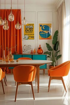 a dining room with orange chairs and art on the wall above it, along with an eclectic style table