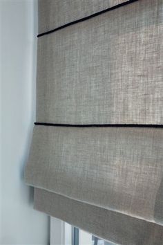 a close up of a window with roman blinds