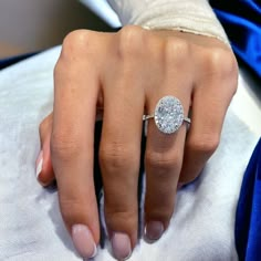 a woman's hand with a diamond ring on it