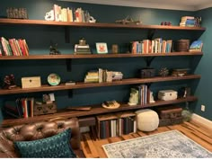 a living room filled with furniture and lots of bookshelves on top of it