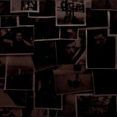 black and white photo collage with many pictures on it's wall in the dark