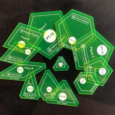 several green tags with white and yellow stickers in the shape of hexagons