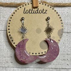 the earrings are made from wood and have purple druzby paint on them,