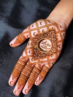 the hand is decorated with henna designs