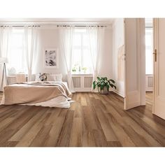 a bedroom with wood floors and white walls