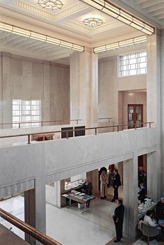 people are standing in the middle of a large building