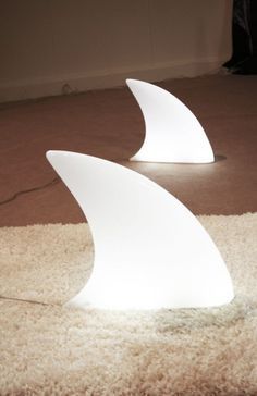 two white lamps sitting on top of a rug