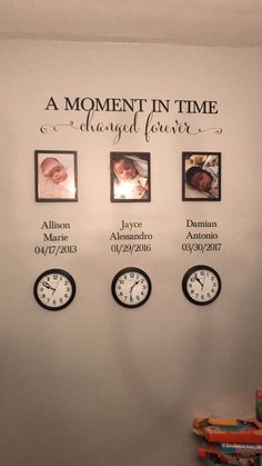 a wall with clocks and family pictures on it's sides that says, a moment in time is always changed forever