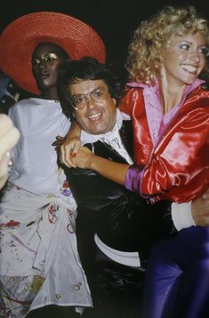 "UNKNOWN PHOTOGRAPHER Grace Jones, producer Allan Carr and Olivia Newton-John, Studio 54 Photo-Litho Printed circa late 20th century 13 5/8\" x 8 7/8\" (Image Size)" Studio 54 Photos, Disco Queen, 70s Nostalgia, Disco Fashion, Olivia Newton, Litho Print, Disco Era, Grace Jones