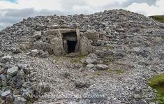 a large pile of rocks on top of a hill with a tunnel in the middle