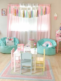 a child's play room with pink and blue accessories on the table, two children's chairs