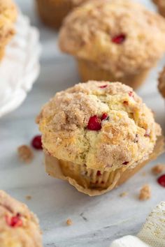 muffins with cranberries and other toppings on a table