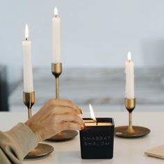 a person lighting candles on a table