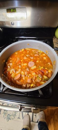 a bowl of soup sitting on top of an oven