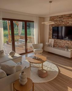 a living room filled with furniture and a flat screen tv mounted on the wall above a fireplace