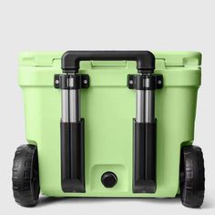 a green cooler with wheels and two black handles