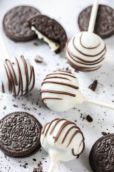 chocolate covered oreo pops are on a white surface