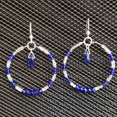 Hoop Earrings Sparkle With Royal Blue Rondelle Crystals And Silvery-Clear Faceted Half-Bugle Beads. A Royal Blue Teardrop Crystal Dangles In The Middle. Hoops Are 1 3/4"/4cm In Diameter And Hang 2 1/4"6cm From The Ear Wire. Brand New, Never Worn Nwot. Handmade By Me, The Sparkliefiend! Part Of 3-For-$20 Deal! Blue Hypoallergenic Hoop Jewelry, Hypoallergenic Blue Hoop Jewelry, Blue Metal Dangle Hoop Earrings, Blue Hypoallergenic Small Hoop Jewelry, Hypoallergenic Blue Small Hoop Jewelry, Nickel-free Blue Small Hoop Jewelry, Blue Metal Hoop Earrings, Adjustable Small Hoop Earrings In Blue, Blue Hoop Earrings With Ear Wire