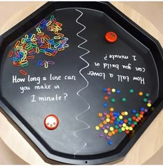 a black tray with writing on it that says how long a line can you make in 1 minute?