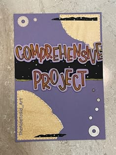 there is a purple book with the words compenensive project written on it